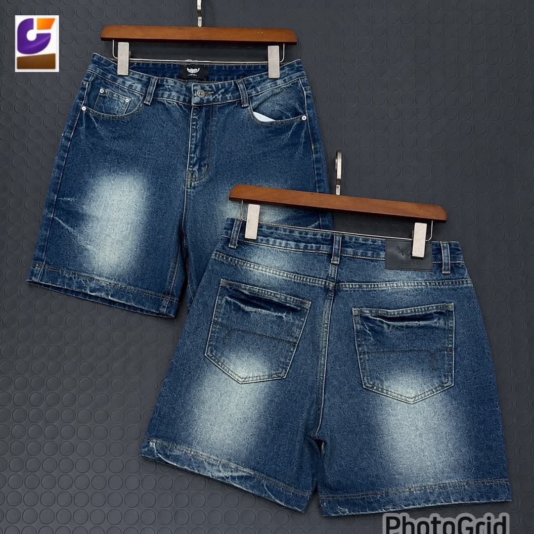 Black denim shorts with white script print on side, shown in front and back views on hangers.