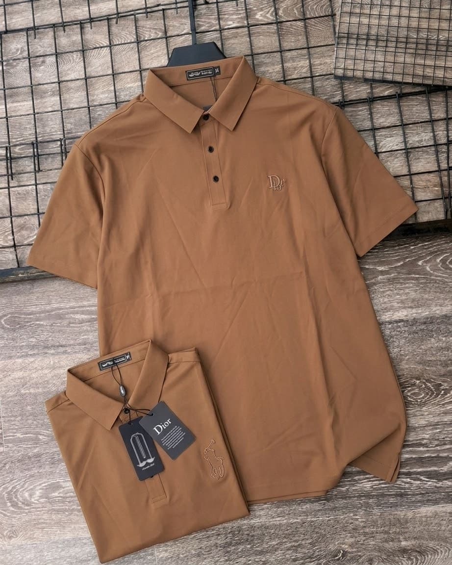 Brown short sleeve polo shirt on hanger and folded, showing Dior embroidery, polo player detail and tags.
