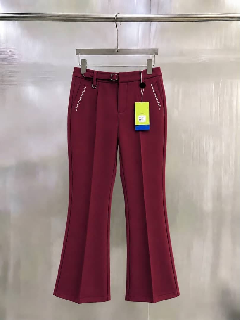 Burgundy flare trousers with white zigzag embroidery, belt and buckle.