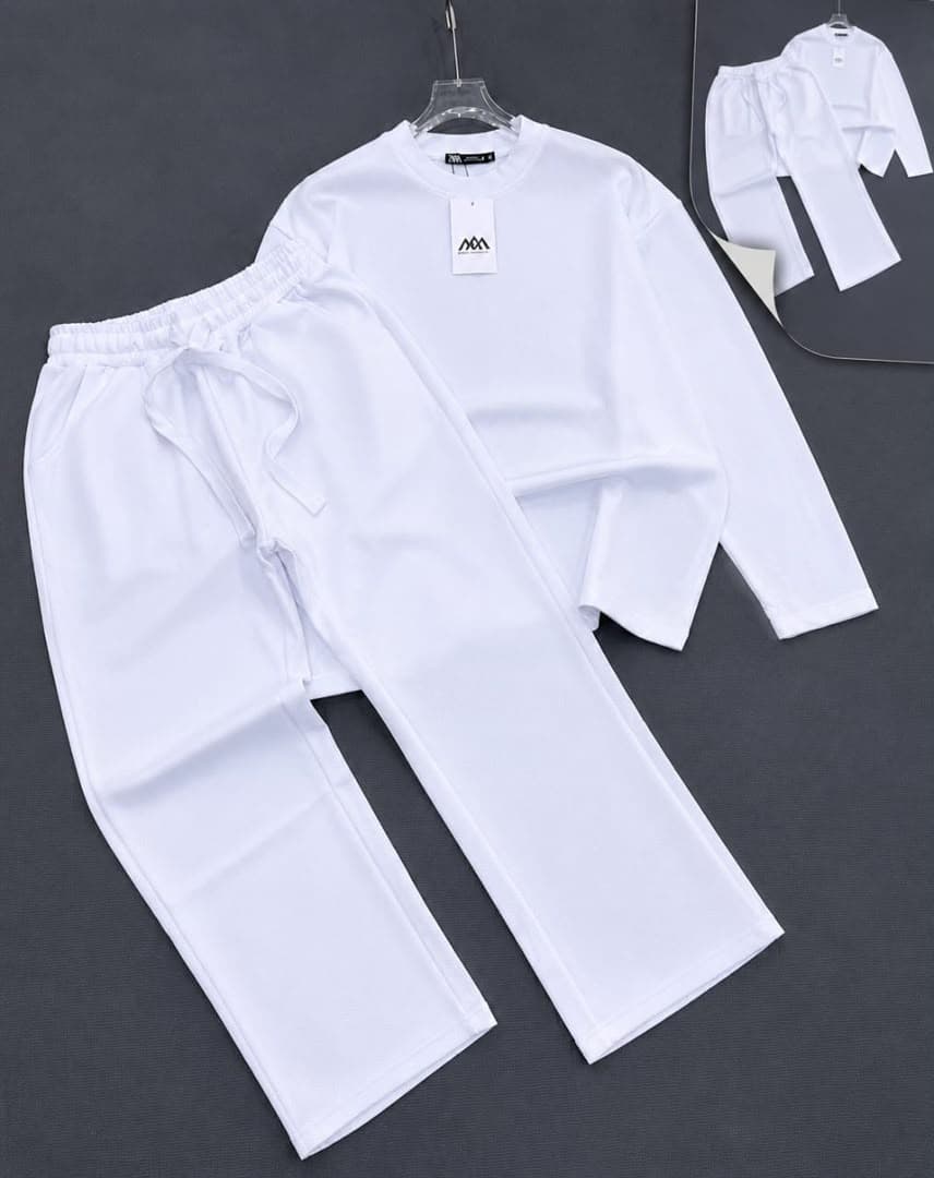 White oversized long sleeve crewneck top and matching drawstring pants two-piece set.