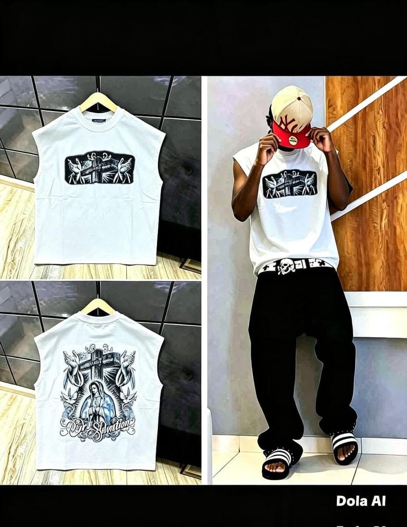 Black sleeveless tee with religious cross graphic on front and detailed Virgin Mary 'Our Salvation' print on back, shown on model and hanger.
