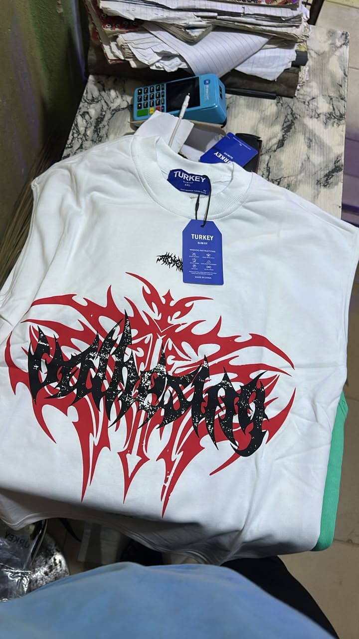 White sleeveless tee with LIMITLESS text and face covering eyes graphic on front and back, shown on hanger and model wearing it.