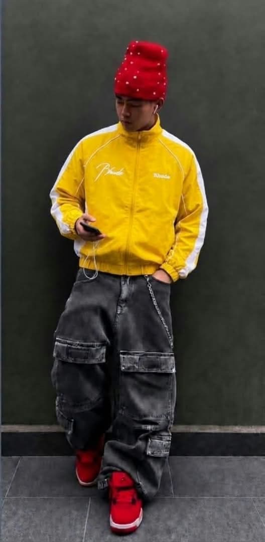 Yellow Rhude track jacket with white contrast sleeves and script logo.