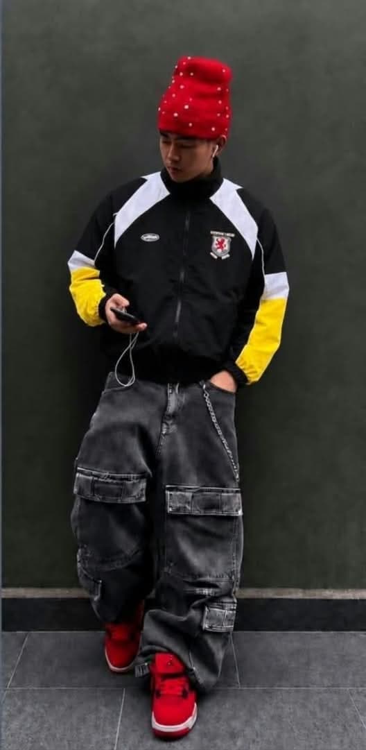 Black colorblock crest track jacket with yellow and white sleeve panels.
