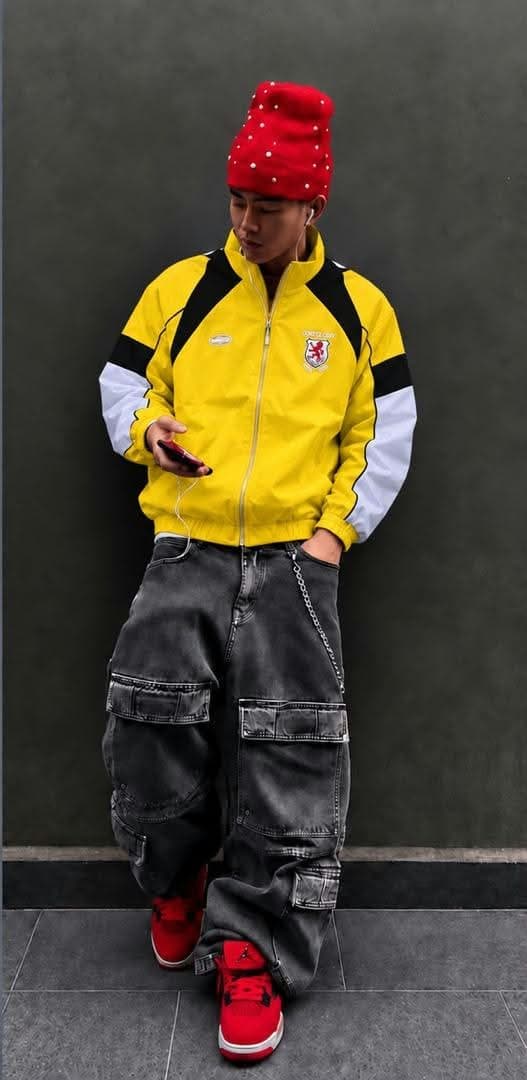 Yellow colorblock crest track jacket with black shoulders and white sleeves.