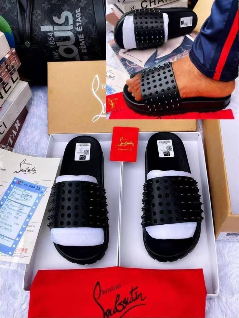 Christian Louboutin black studded slides in box with red dust bag and documents.
