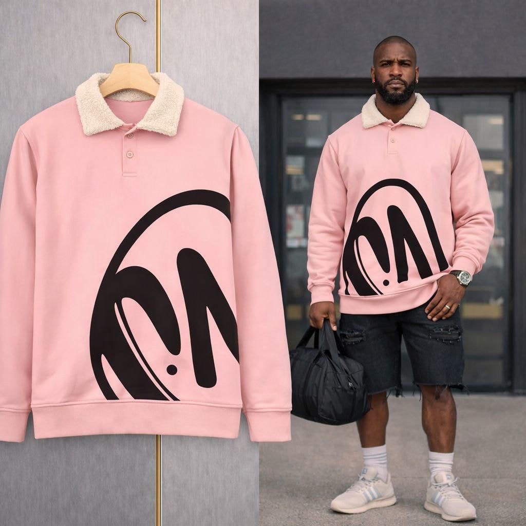 Pink polo sweatshirt with black abstract graphic on hanger and model.