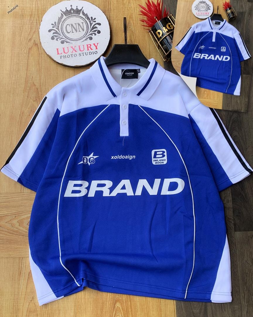 Blue and white colorblock polo shirt with large BRAND print.