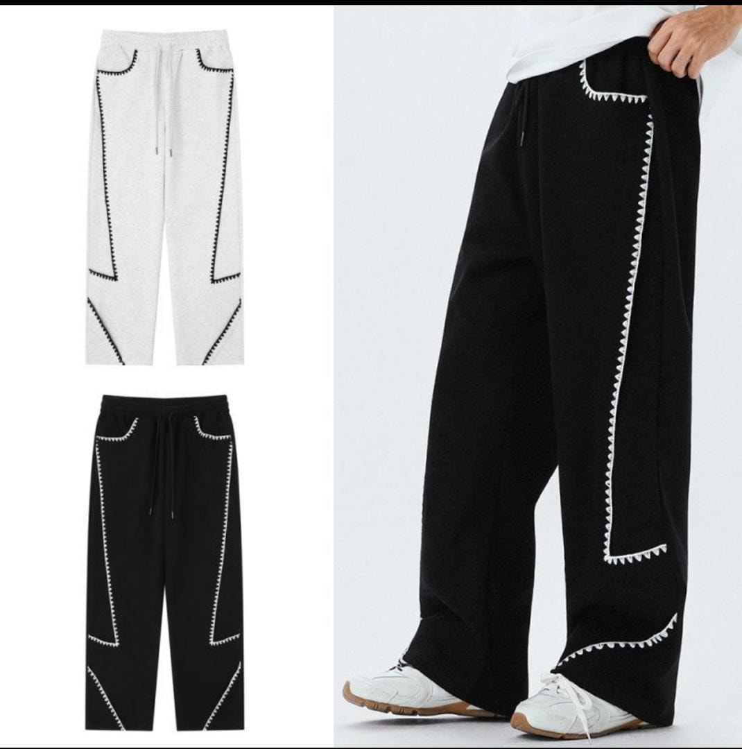 Gray and black joggers with zigzag contrast stitching on pockets and side seams.